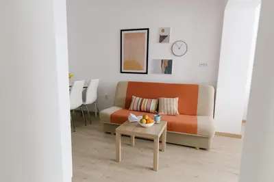 a living room with a couch and a table at Apartmani Veselinović in Vrnjačka Banja