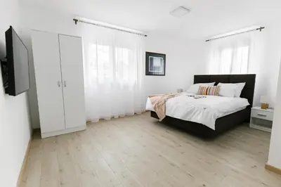 a bedroom with a bed and a television in it at Apartmani Veselinović in Vrnjačka Banja