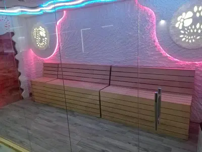 a row of benches in a room with neon lights at MILMARI APARTMAN P03 in Kopaonik