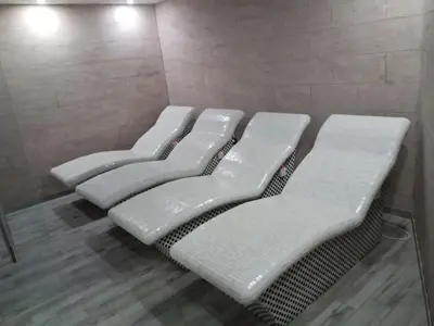 a row of four white benches in a room at MILMARI APARTMAN P03 in Kopaonik