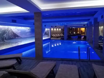 a pool in a hotel with a painting on the wall at MILMARI APARTMAN P03 in Kopaonik