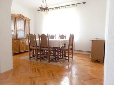 a dining room with a white table and chairs at Vila Nikola in Soko Banja