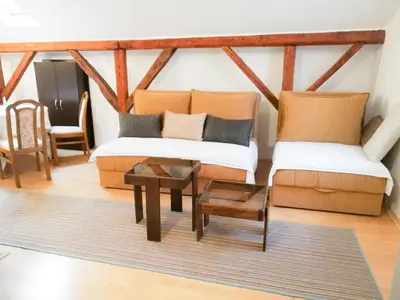 a living room with two couches and a coffee table at Vila Nikola in Soko Banja