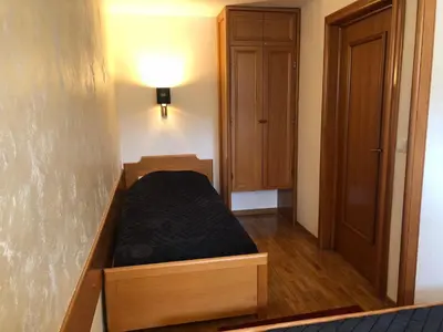 a bedroom with a bed in a wooden frame at Apartman 602 in Kopaonik