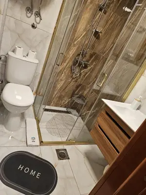 a bathroom with a shower and a toilet and a sink at Apartman 602 in Kopaonik