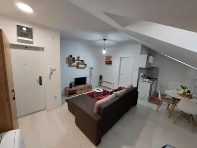 a living room with a couch and a table at Apartman ST.Nedeljkovic Sokobanja in Soko Banja