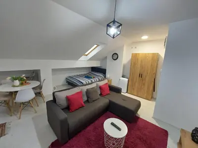 a living room with a couch and a table at Apartman ST.Nedeljkovic Sokobanja in Soko Banja