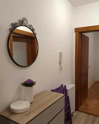 a bathroom with a mirror on the wall at LILAC Apartment in Vrnjačka Banja