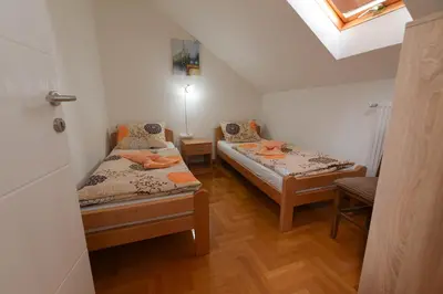 a small room with two beds and a window at Capitol Apartmani in Vrnjačka Banja