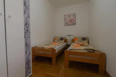 a room with two beds in a room at Capitol Apartmani in Vrnjačka Banja