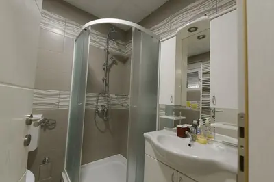 a bathroom with a shower and a sink at Capitol Apartmani in Vrnjačka Banja