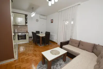 a living room with a couch and a table at Capitol Apartmani in Vrnjačka Banja