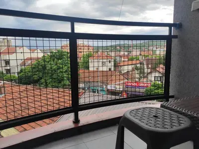 a window with a view of a city at Modern cozy apartment in Niš