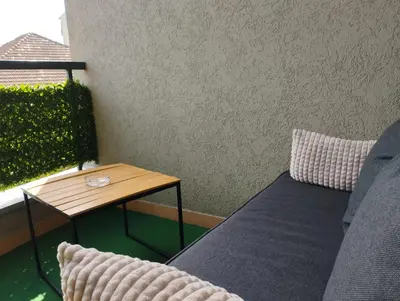 a small table next to a couch next to a wall at Studio City day in Jagodina