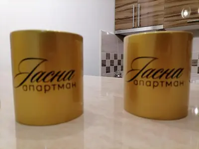 two yellow cups sitting on top of a counter at Apartman Jasna in Vrnjci