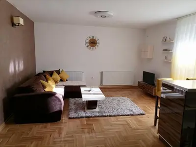 a living room with a couch and a table at Apartman Jasna in Vrnjci