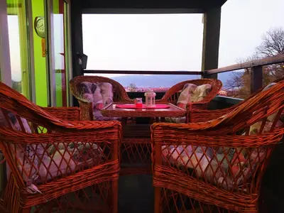 a patio with a table and chairs and a window at Apartman Jasmin in Vrnjačka Banja