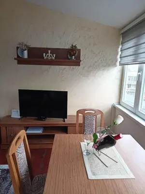 a dining room with a table and a television at Apartman Jasmin in Vrnjačka Banja