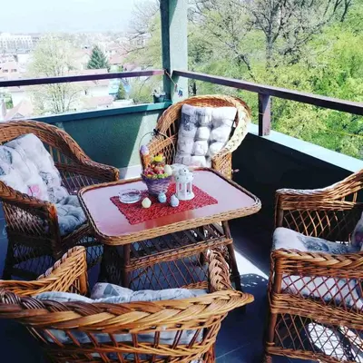 a porch with wicker chairs and a table and a tableablish at Apartman Jasmin in Vrnjačka Banja