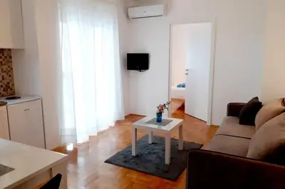 a living room with a couch and a table at Smeštaj Voli - Apartman u centru Sokobanje in Soko Banja