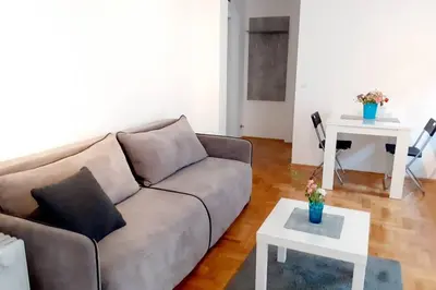 a living room with a couch and a table at Smeštaj Voli - Apartman u centru Sokobanje in Soko Banja
