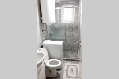 a small bathroom with a toilet and a shower at Smeštaj Voli - Apartman u centru Sokobanje in Soko Banja