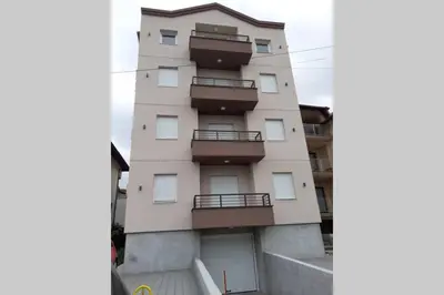 a building with balconies on the side of it at Smeštaj Voli - Apartman u centru Sokobanje in Soko Banja