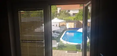 a window with a view of a swimming pool at AquaLux 2 in Soko Banja