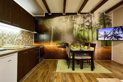 a kitchen with a dining table with a painting on the wall at AquaLux 2 in Soko Banja