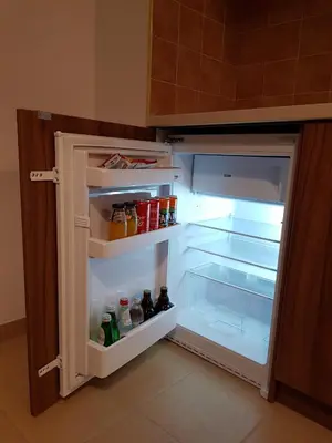 an empty refrigerator with its door open in a kitchen at Apartman Esperanza in Vrnjačka Banja