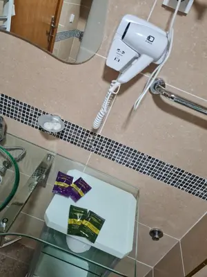 a hair dryer sitting on a counter next to a mirror at Apartman Esperanza in Vrnjačka Banja