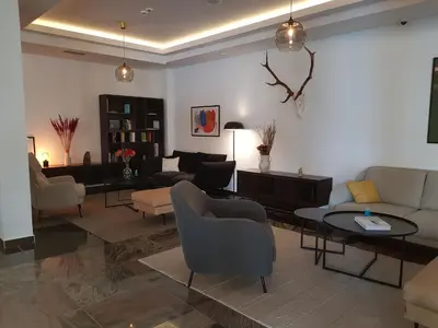 a living room with a couch and chairs and a table at Apartman Esperanza in Vrnjačka Banja