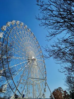 a large ferris wheel against a blue sky at Apartman Esperanza in Vrnjačka Banja