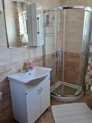 a bathroom with a sink and a shower at Apartman TIM LUX 2 in Vrnjačka Banja