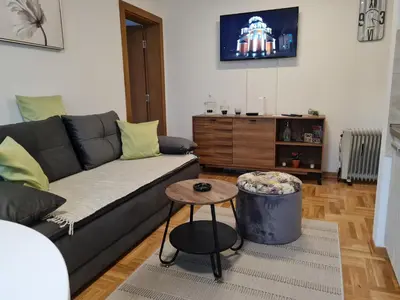 a living room with a couch and a table at Apartman TIM LUX 2 in Vrnjačka Banja