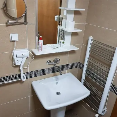 a bathroom with a white sink and a mirror at Apartman Ibarstar in Vrnjačka Banja