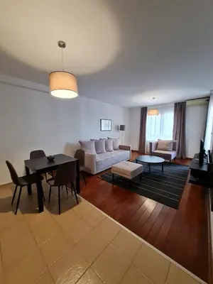 a living room with a couch and a table at Apartman Ibarstar in Vrnjačka Banja