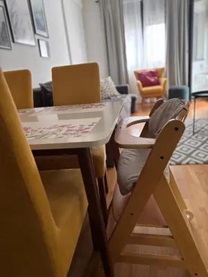 a dining room table with a chair under it at Enigma in Vrnjačka Banja