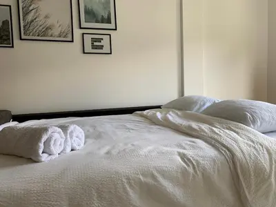 a white bed with towels on top of it at Enigma in Vrnjačka Banja