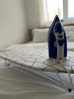 a blue and white bottle sitting on top of a bed at Enigma in Vrnjačka Banja