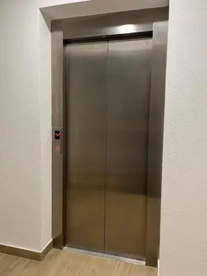 a elevator with a metal door in a building at Enigma in Vrnjačka Banja