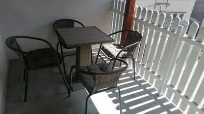 a table and chairs sitting on a balcony at Apartman Andrijana 1 in Soko Banja
