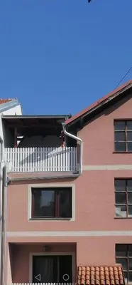 a building with a balcony on top of it at Apartman Andrijana 1 in Soko Banja