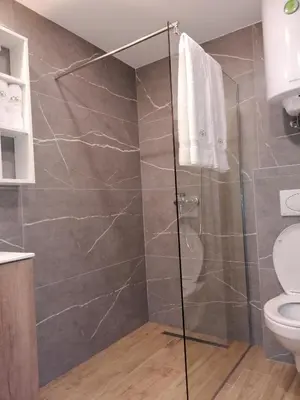 a bathroom with a shower and a toilet at President Kop - Apartman A21 in Kopaonik