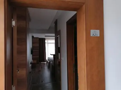 a room with a door with a sign on it at President Kop - Apartman A21 in Kopaonik