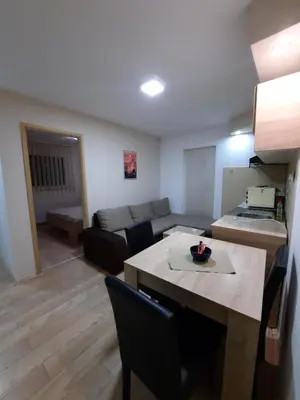 a living room with a table and a couch at Apartmani Tvins in Soko Banja