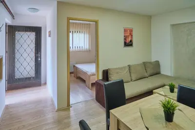 a living room with a couch and a table at Apartmani Tvins in Soko Banja