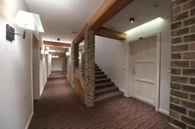 a hallway with stairs and a brick wall at Central Residence by Župa in Kopaonik