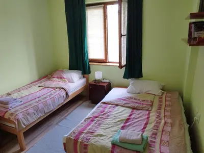 two beds in a room with a window at Stancic 019 in Zaječar