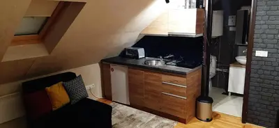 a small kitchen with a sink and a sink at Kraljevi čardaci, apartman 53 u zgradi 7, opcija unutrašnjeg parking mesta in Kopaonik